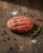 Beef kafta skewers with fresh parsley on butcher paper at Boucherie Beirut Laval