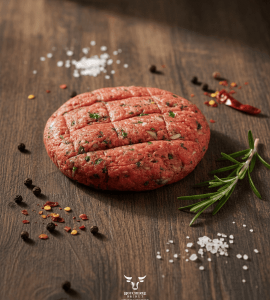 Beef kafta skewers with fresh parsley on butcher paper at Boucherie Beirut Laval