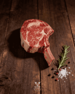 Cowboy steak tomahawk bone-in ribeye on butcher paper at Boucherie Beirut Laval