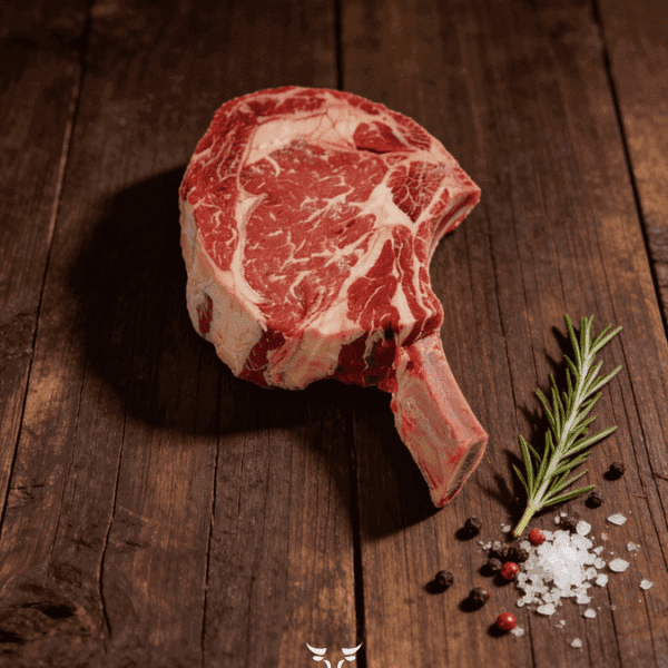 Cowboy steak tomahawk bone-in ribeye on butcher paper at Boucherie Beirut Laval