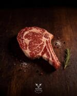 Ribeye steak raw — rich marbling detail, Certified Angus