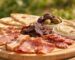 Halal charcuterie board for BBQ with beef bacon, smoked meat, dried beef, flatbread, olives and hummus outdoors – Boucherie Beirut Laval