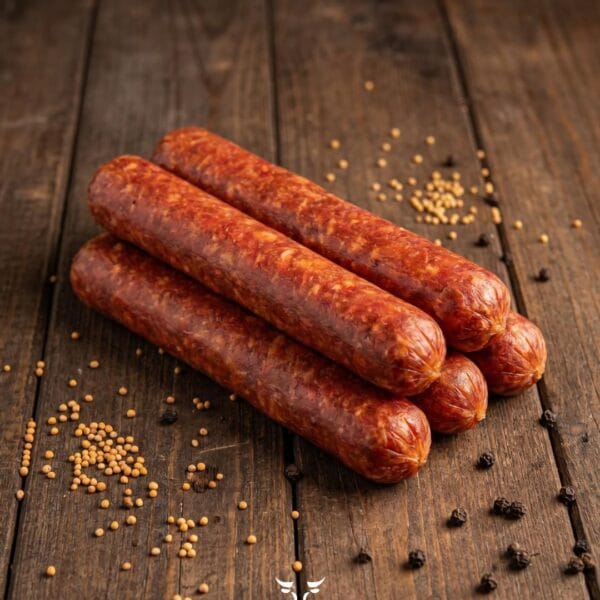 Hotdog beef sausage with mustard seeds and black peppercorns on a rustic wooden surface – Boucherie Beirut Laval