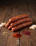 sojok-beef-sausage-boucherie-beirutjpg | Boucherie Beirut Sojok beef sausage with paprika red chili and black pepper on a rustic wooden surface – Boucherie Beirut Laval