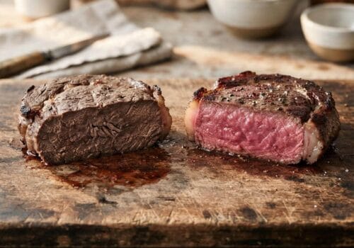 Steak mistakes comparison showing overcooked grey steak versus perfect medium-rare pink centre on a wooden board – Boucherie Beirut Laval