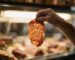 Butcher hand holding a thin wagyu slice up to butcher shop light revealing extraordinary BMS 9+ marbling – Boucherie Beirut Laval