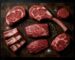 Beef cuts laid out on a butcher block including ribeye tomahawk filet mignon brisket and short ribs